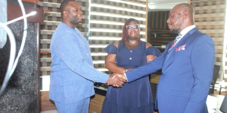 Bernard Owusu-Twumasi [Right] in a handshake with UGSoL's Kwame Awadzie